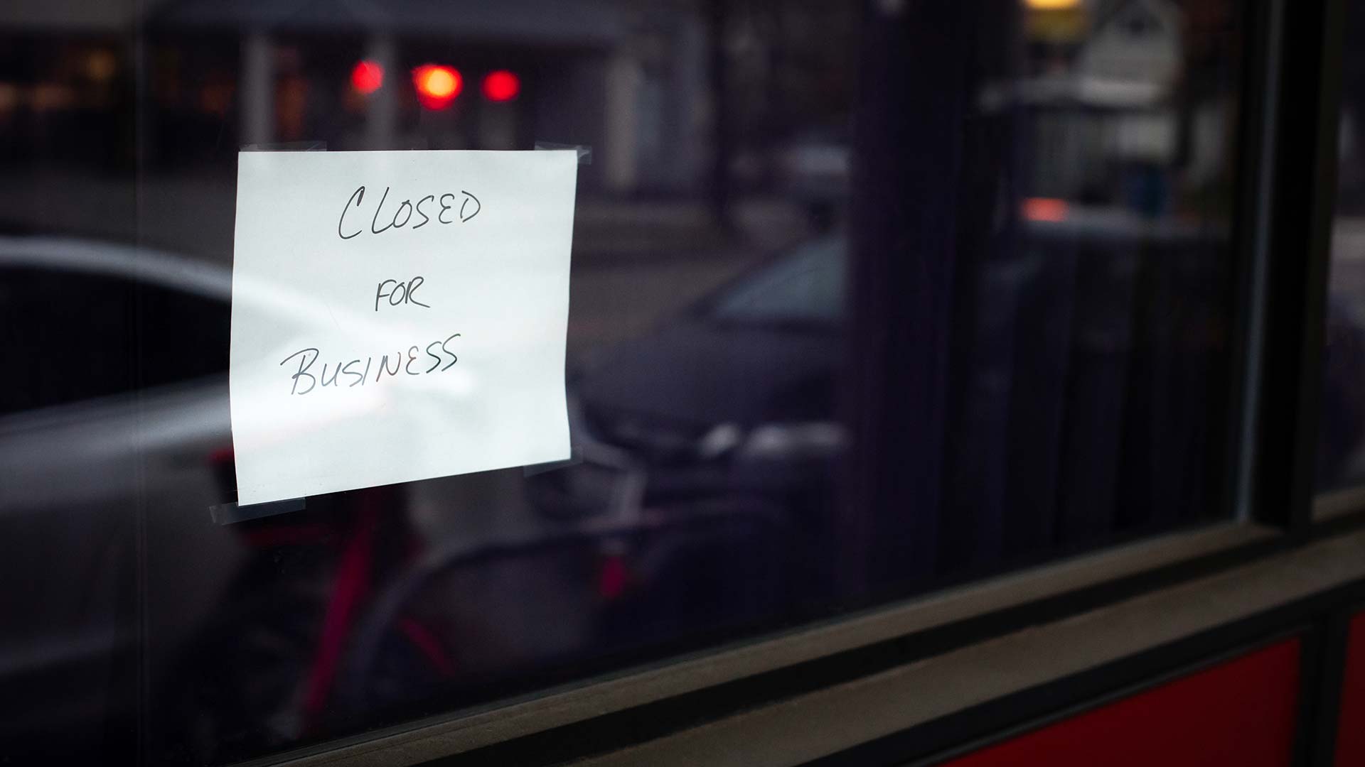 Closed sign on a storefront window